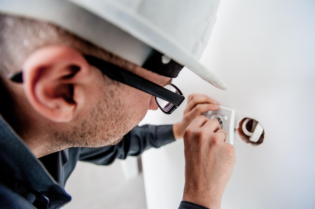 Electrician installing a wall socket